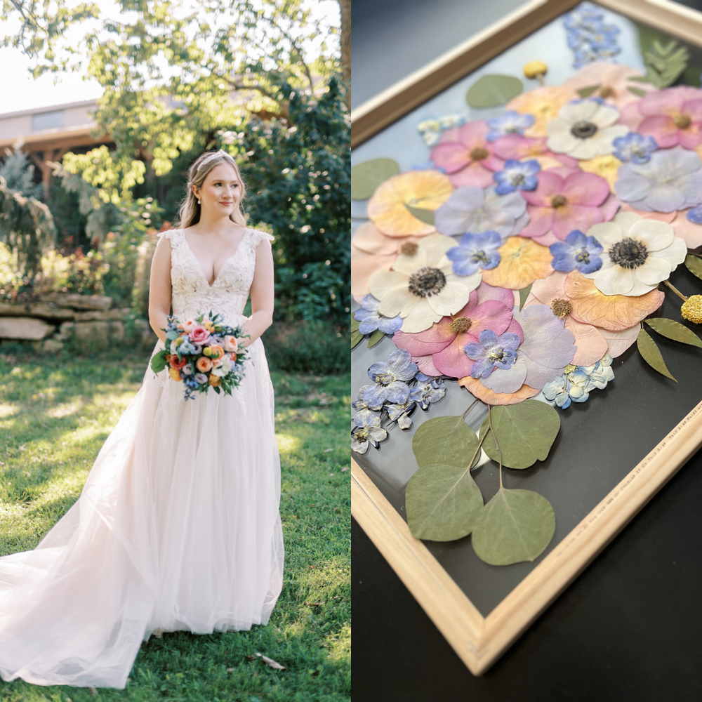 On the left, a bride in a delicate lace gown stands in a sunlit garden, holding a colorful bouquet of peach, pink, and blue blooms, framed by lush greenery. She has a gentle smile and a soft, romantic expression. On the right, the pressed floral art beautifully replicates the bride's bouquet, featuring soft pastel flowers in pink, yellow, and blue, along with vibrant anemones and green eucalyptus leaves. The framed artwork captures the vibrant essence of the wedding flowers, preserving them as a timeless me